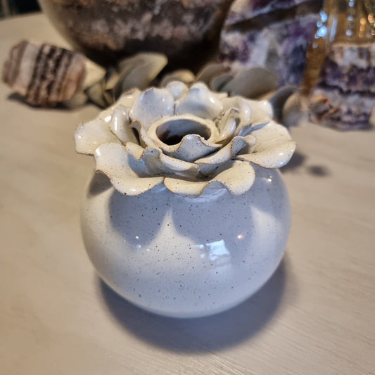 Sculptural ceramic bud vase with rose-shaped petal rim in cream glaze and speckled blue-grey body