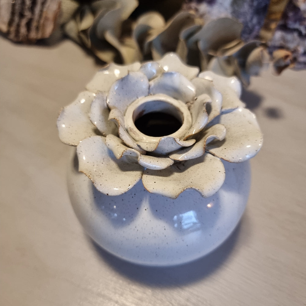 Sculptural ceramic bud vase with rose-shaped petal rim in cream glaze and speckled blue-grey body