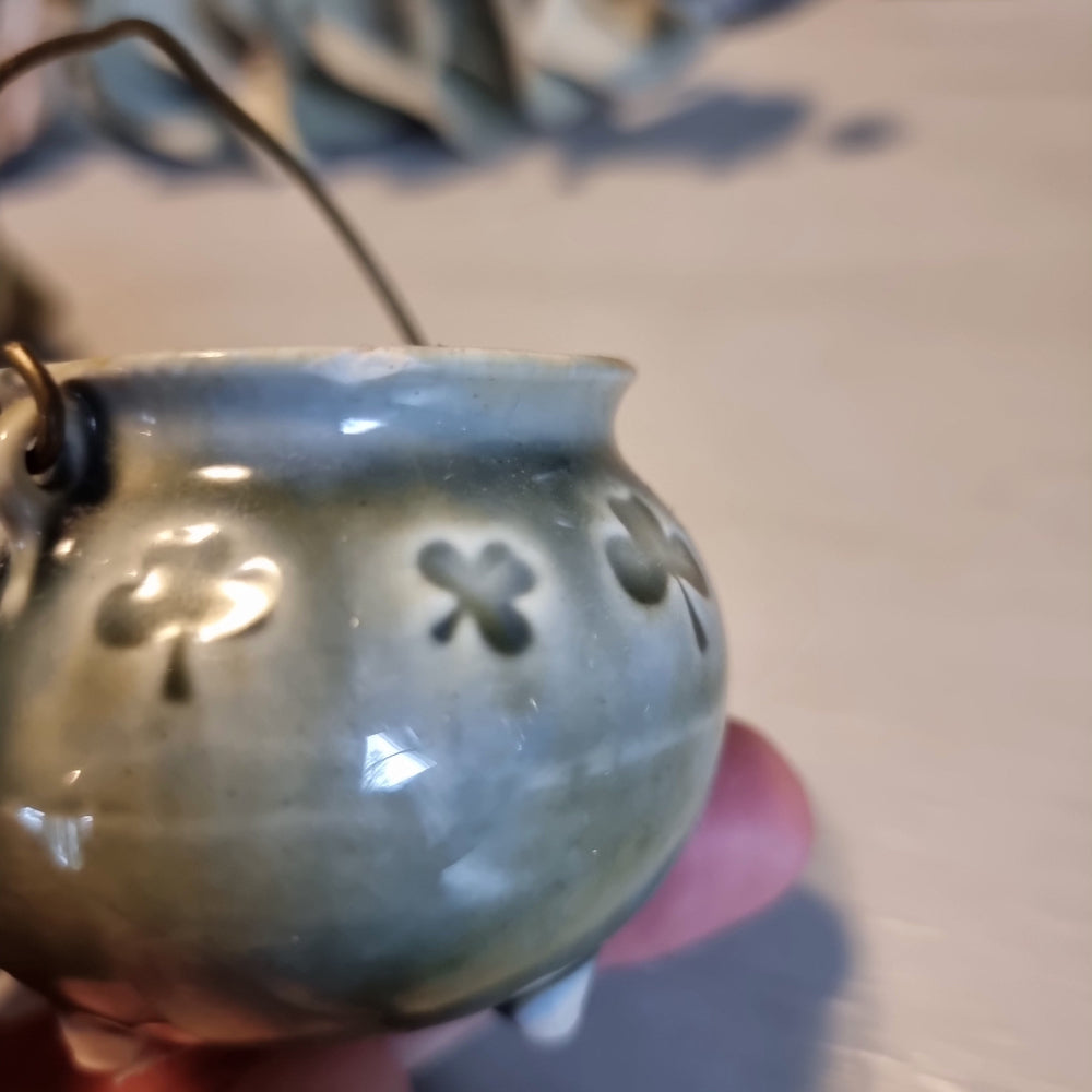 Trio of vintage Wade shamrock dishes in grey-blue glaze with honey brown highlights, including a footed dish, a pierced pot with wire handle, and a clover-shaped dish