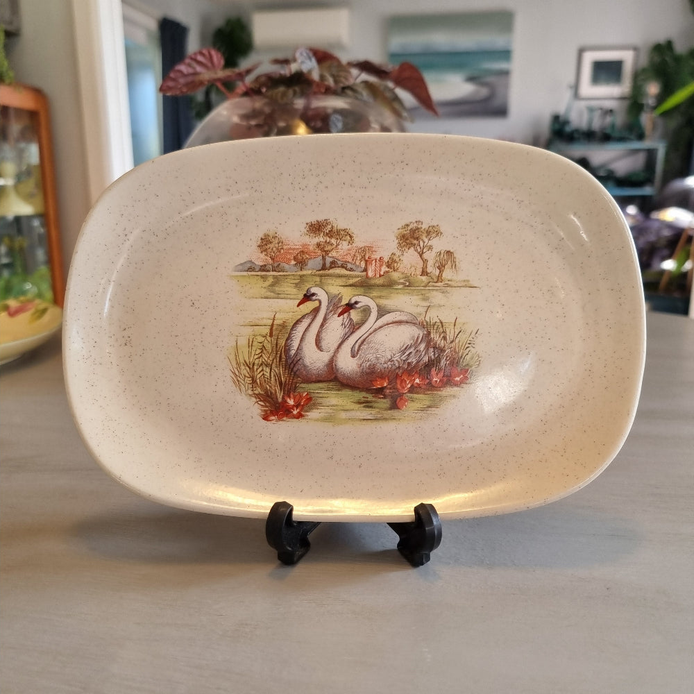 Vintage speckled oval dish with a transfer print of two swans and water lilies