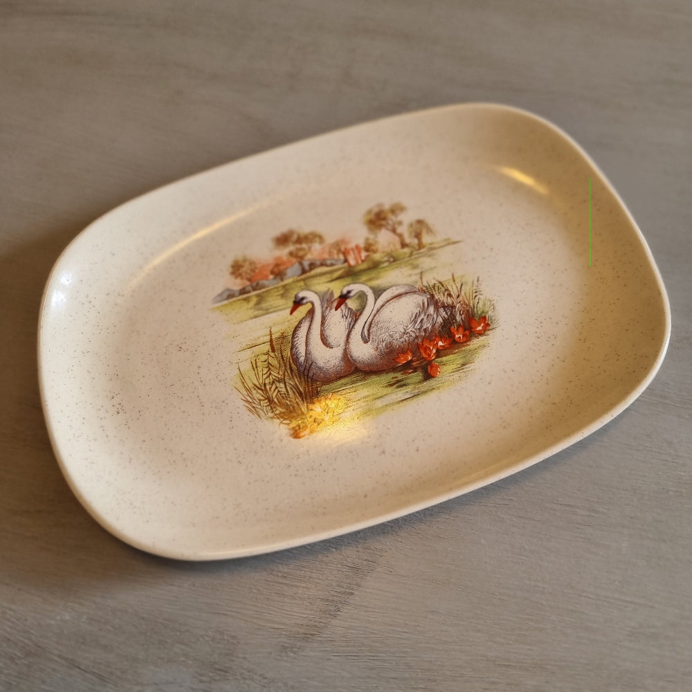 Vintage speckled oval dish with a transfer print of two swans and water lilies