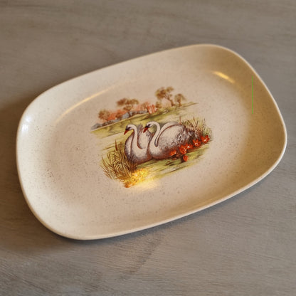 Vintage speckled oval dish with a transfer print of two swans and water lilies