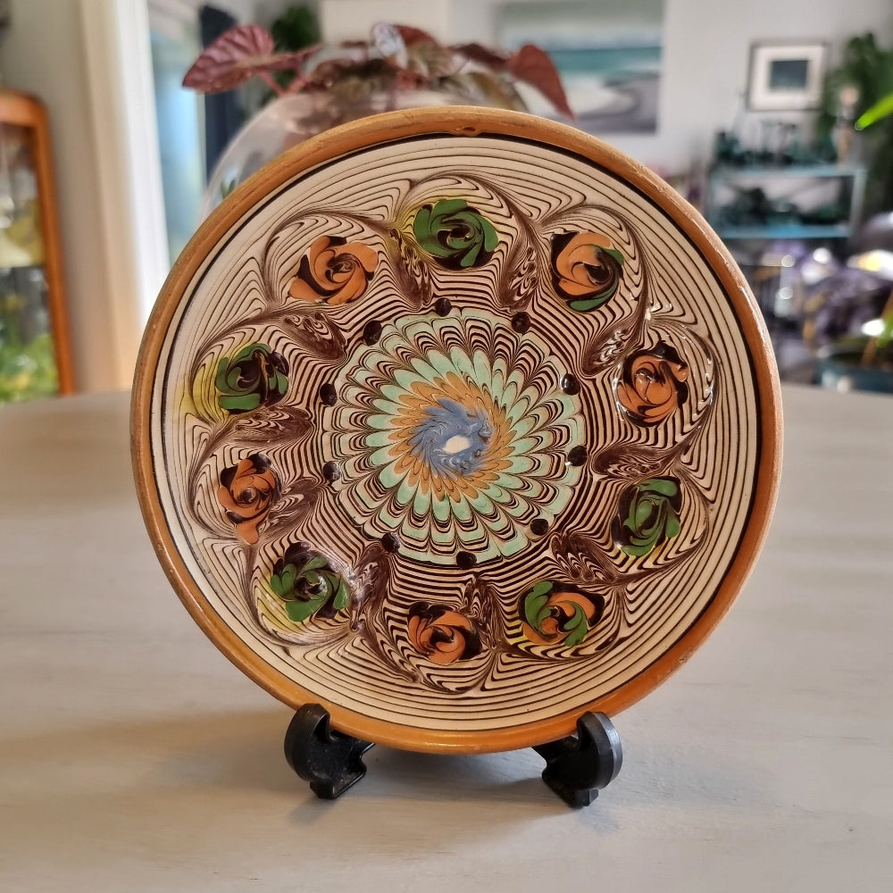 Horezu Romanian marbled clay dish with a swirled glaze and rose motifs