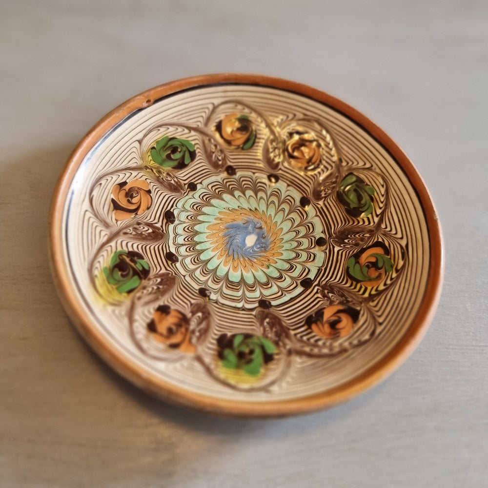 Horezu Romanian marbled clay dish with a swirled glaze and rose motifs