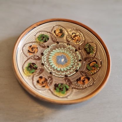 Horezu Romanian marbled clay dish with a swirled glaze and rose motifs