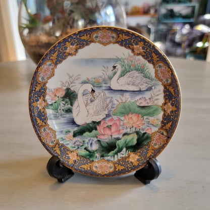 Decorative Japanese porcelain plate with swans and a lotus pond design