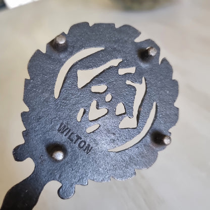 Wilton cast iron trivet with a lovebird and heart wreath design