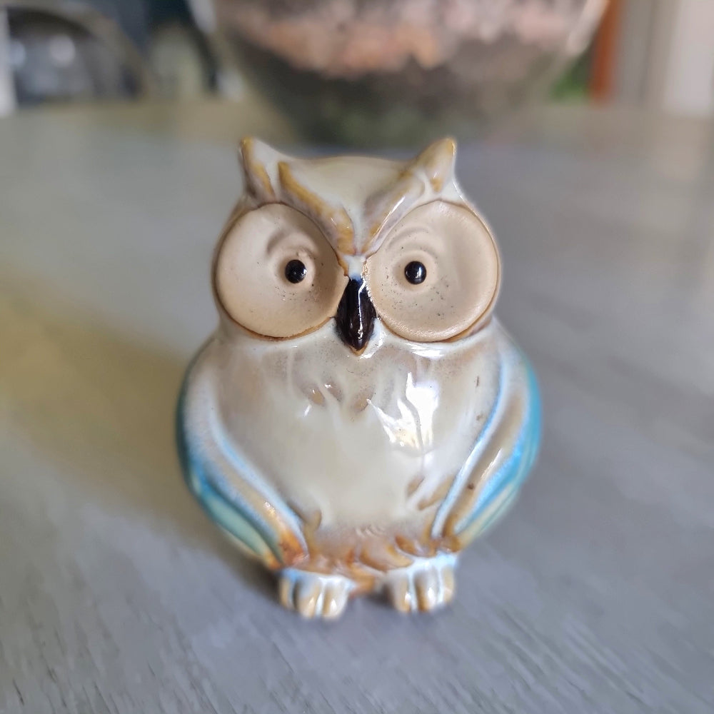 Small ceramic owl figurine with a teal drip glaze