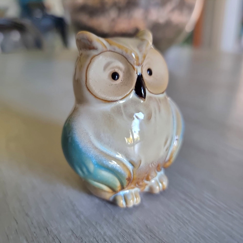 Small ceramic owl figurine with a teal drip glaze