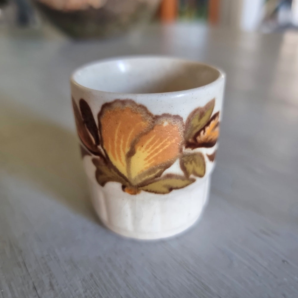 Vintage Palissy egg cup with a hand finished autumn floral design. 