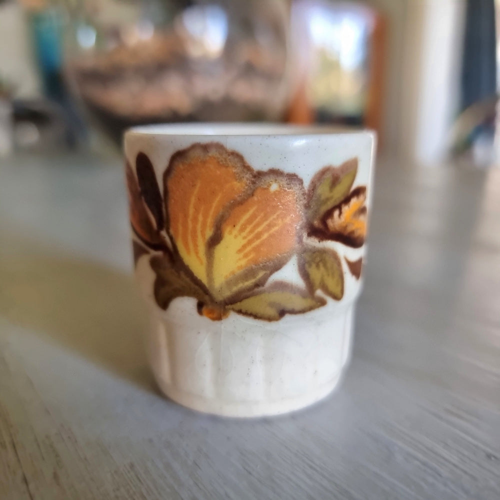 Vintage Palissy egg cup with a hand finished autumn floral design. 