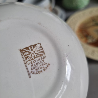 Vintage Weatherby Hanley Royal Falconware plate with a blue butterfly, brown grasses, a small cottage and a gold-toned rim