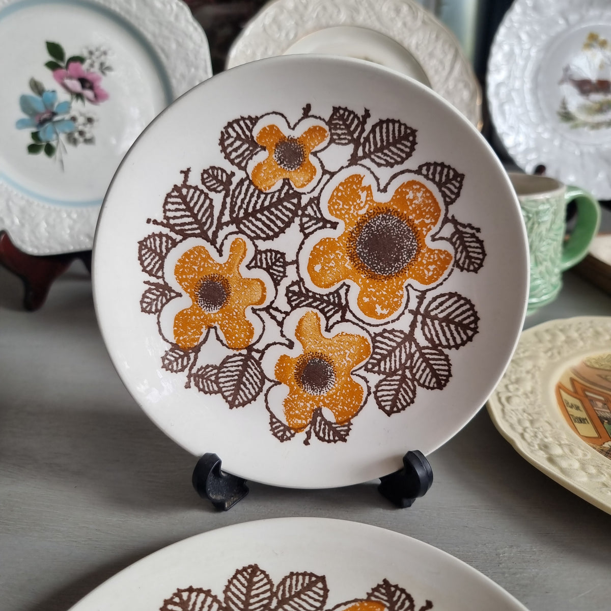Two vintage Kelston Ceramics Virginia plates with orange speckled flowers and brown outlined leaves