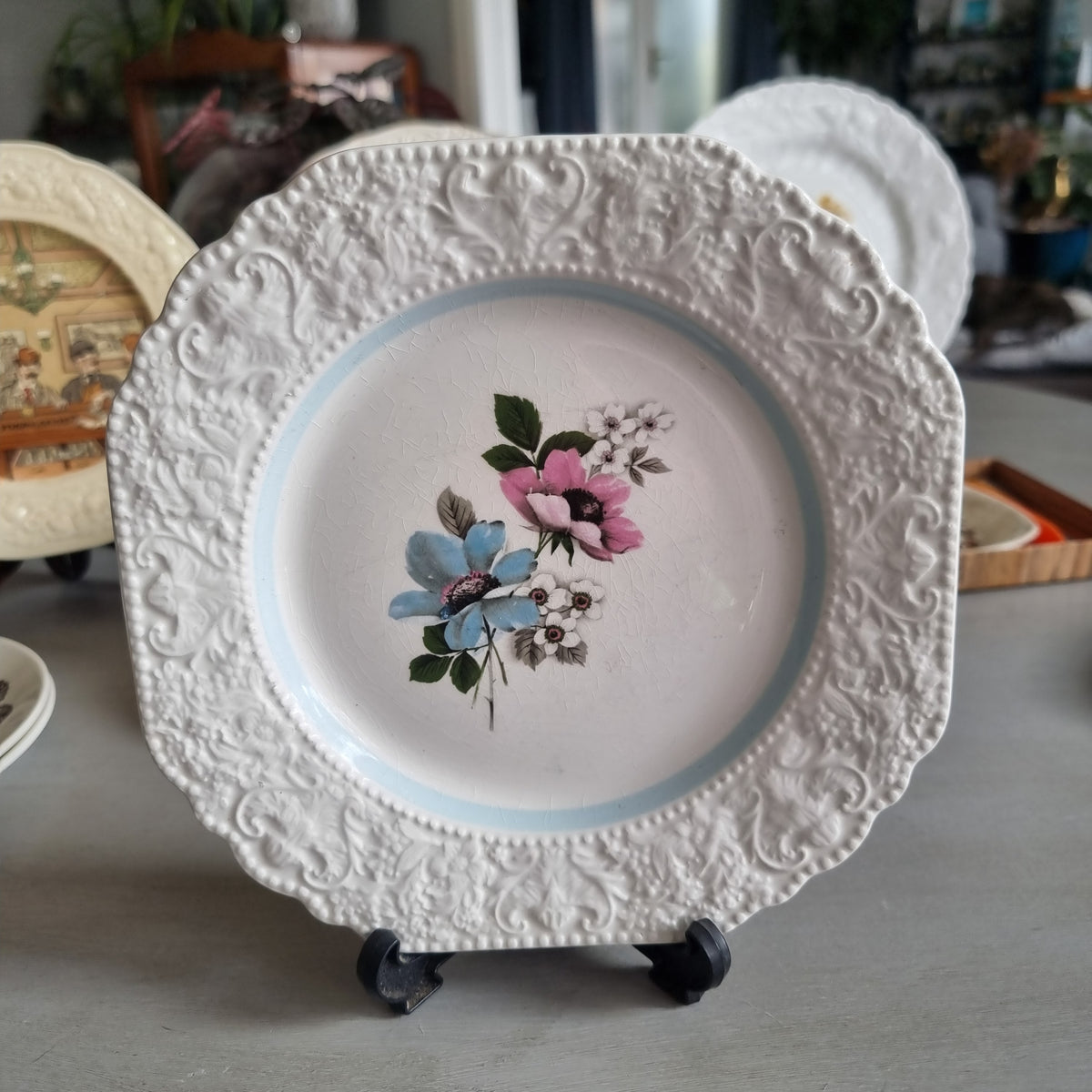 Vintage Lord Nelson Pottery plate with an embossed scroll border, pale blue band and blue and pink flowers