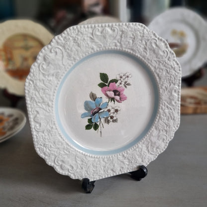Vintage Lord Nelson Pottery plate with an embossed scroll border, pale blue band and blue and pink flowers