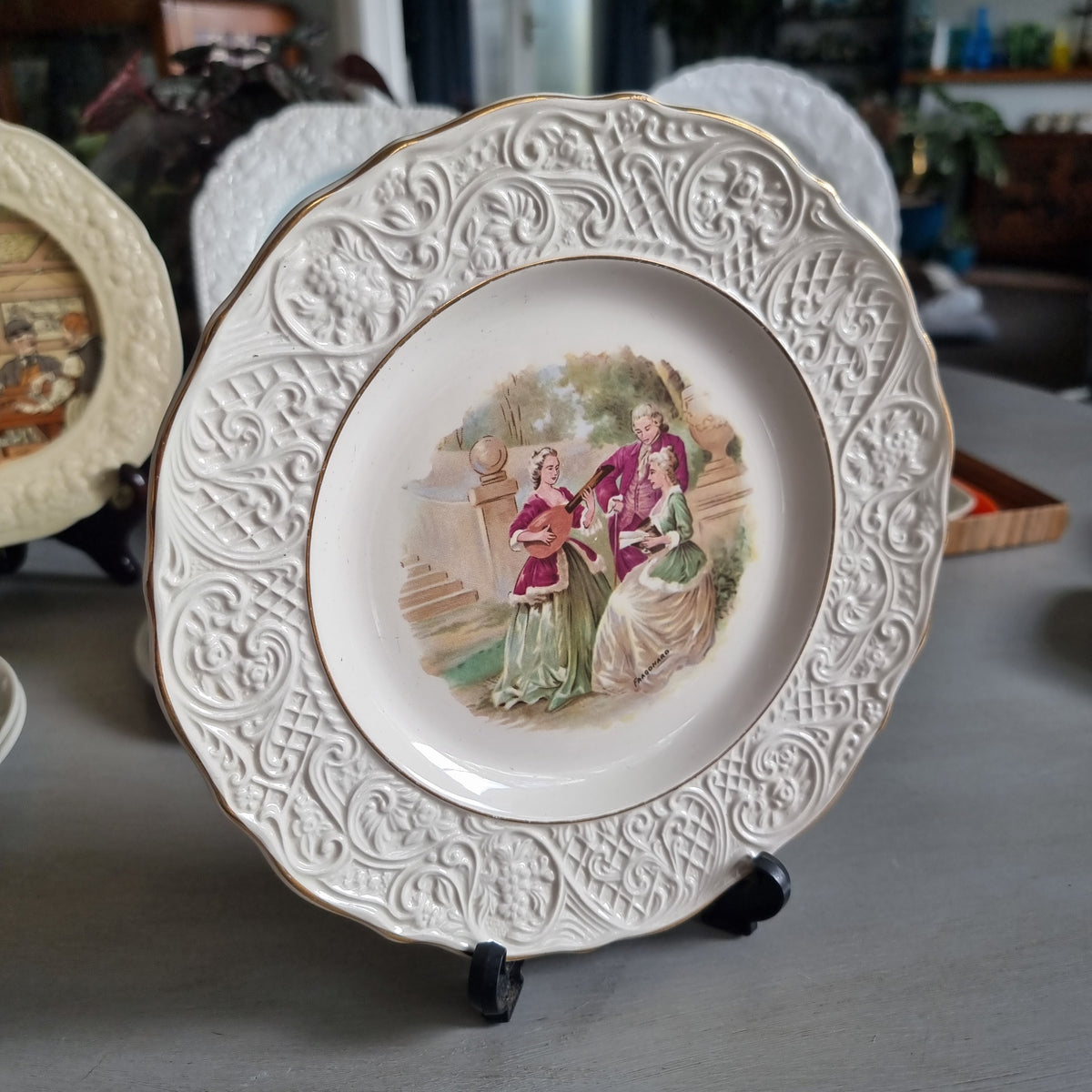 Vintage Solian Ware plate with a garden scene of three musicians in period costume and an embossed scroll border