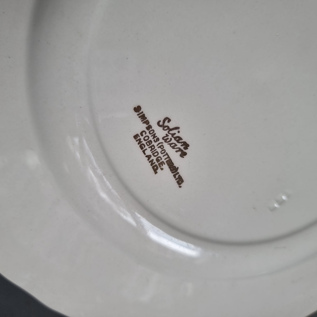 Vintage Solian Ware plate with a garden scene of three musicians in period costume and an embossed scroll border