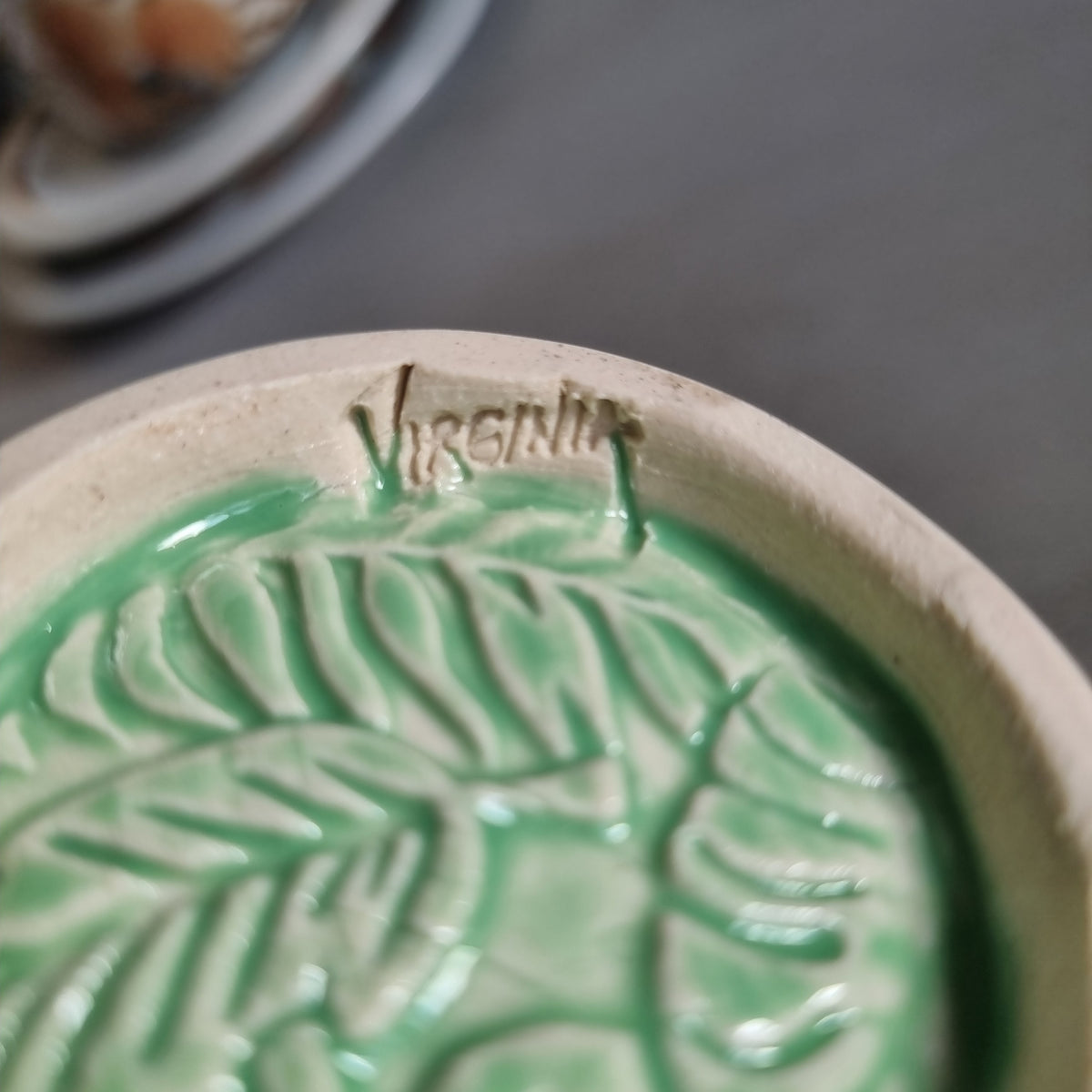 Vintage Virginia NZ made mug with a green glaze and raised fern and leaf pattern
