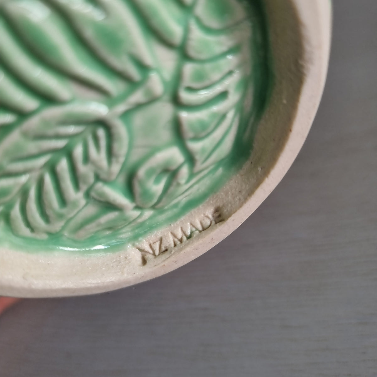Vintage Virginia NZ made mug with a green glaze and raised fern and leaf pattern