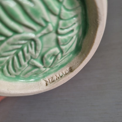 Vintage Virginia NZ made mug with a green glaze and raised fern and leaf pattern