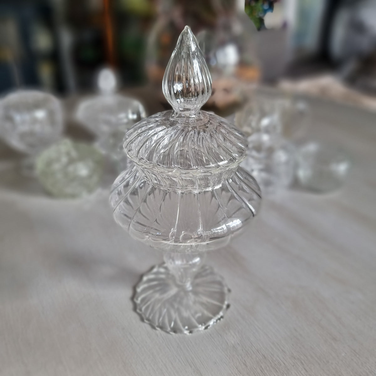 Tall clear glass Mathilde M. Comtesse style bonbonnière with ribbed teardrop finial, swirl ribbed lid and scalloped foot