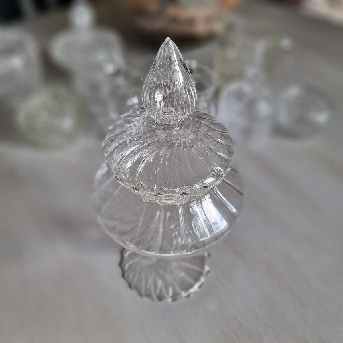 Tall clear glass Mathilde M. Comtesse style bonbonnière with ribbed teardrop finial, swirl ribbed lid and scalloped foot