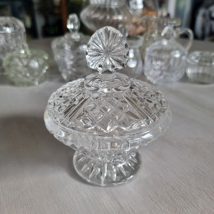 Clear cut glass lidded compote with diamond cut dome lid, fan shaped finial and pedestal foot