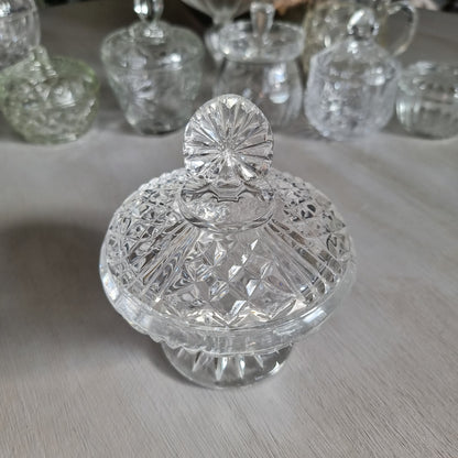 Clear cut glass lidded compote with diamond cut dome lid, fan shaped finial and pedestal foot