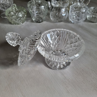 Clear cut glass lidded compote with diamond cut dome lid, fan shaped finial and pedestal foot