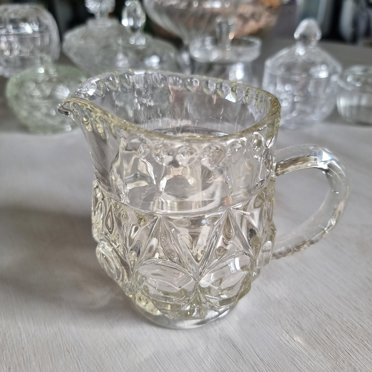 Vintage Bagley Empress pattern clear pressed glass cream jug with thumbprint and star panels and a beaded rim