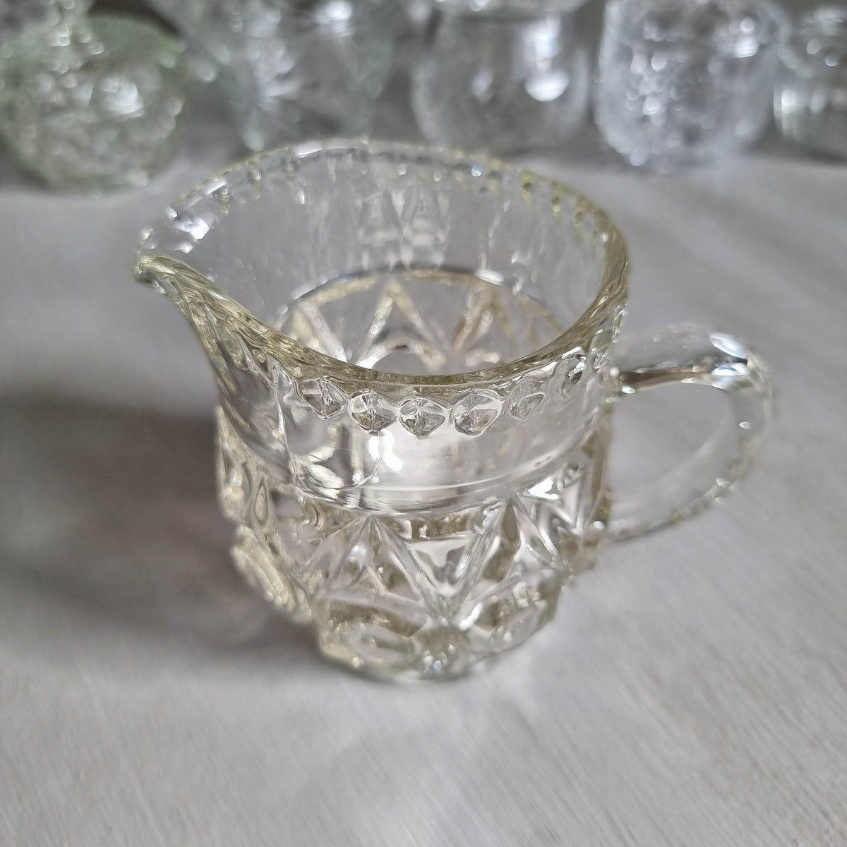 Vintage Bagley Empress pattern clear pressed glass cream jug with thumbprint and star panels and a beaded rim