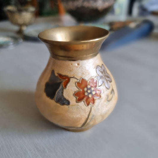 Small brass bud vase with a cream enamel body decorated with rust red, blue and grey flowers