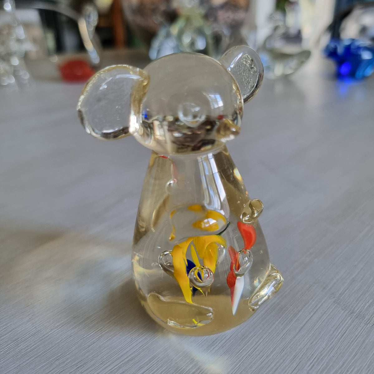 Vintage clear glass bear figurine with confetti-style colour swirls