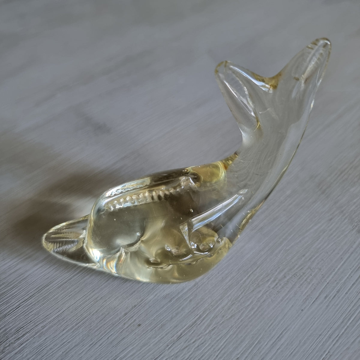 Vintage clear blown glass whale figurine with ridged detailing