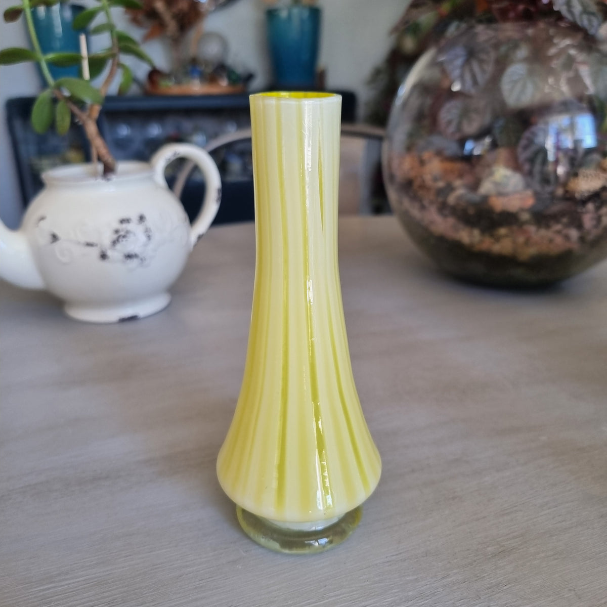 Vintage yellow and white striped glass bud vase with a clear glass foot