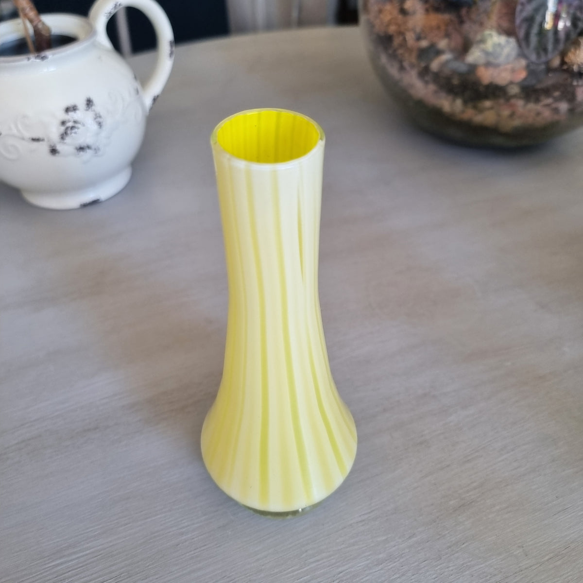 Vintage yellow and white striped glass bud vase with a clear glass foot