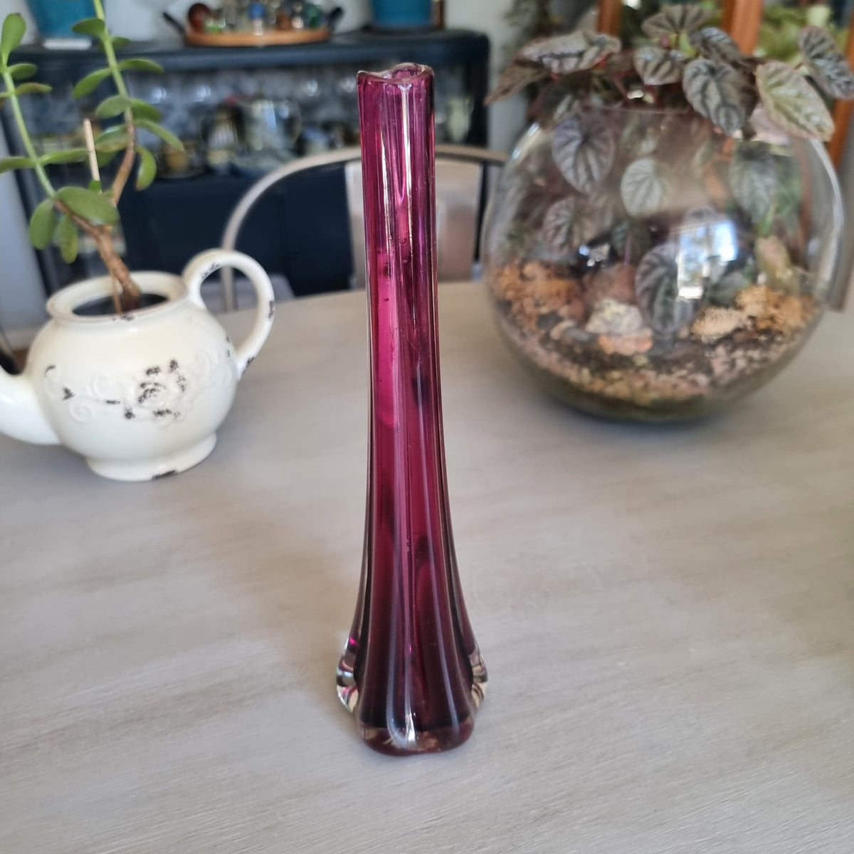Tall vintage purple glass bud vase with ribbed sides and a heavy clear glass base
