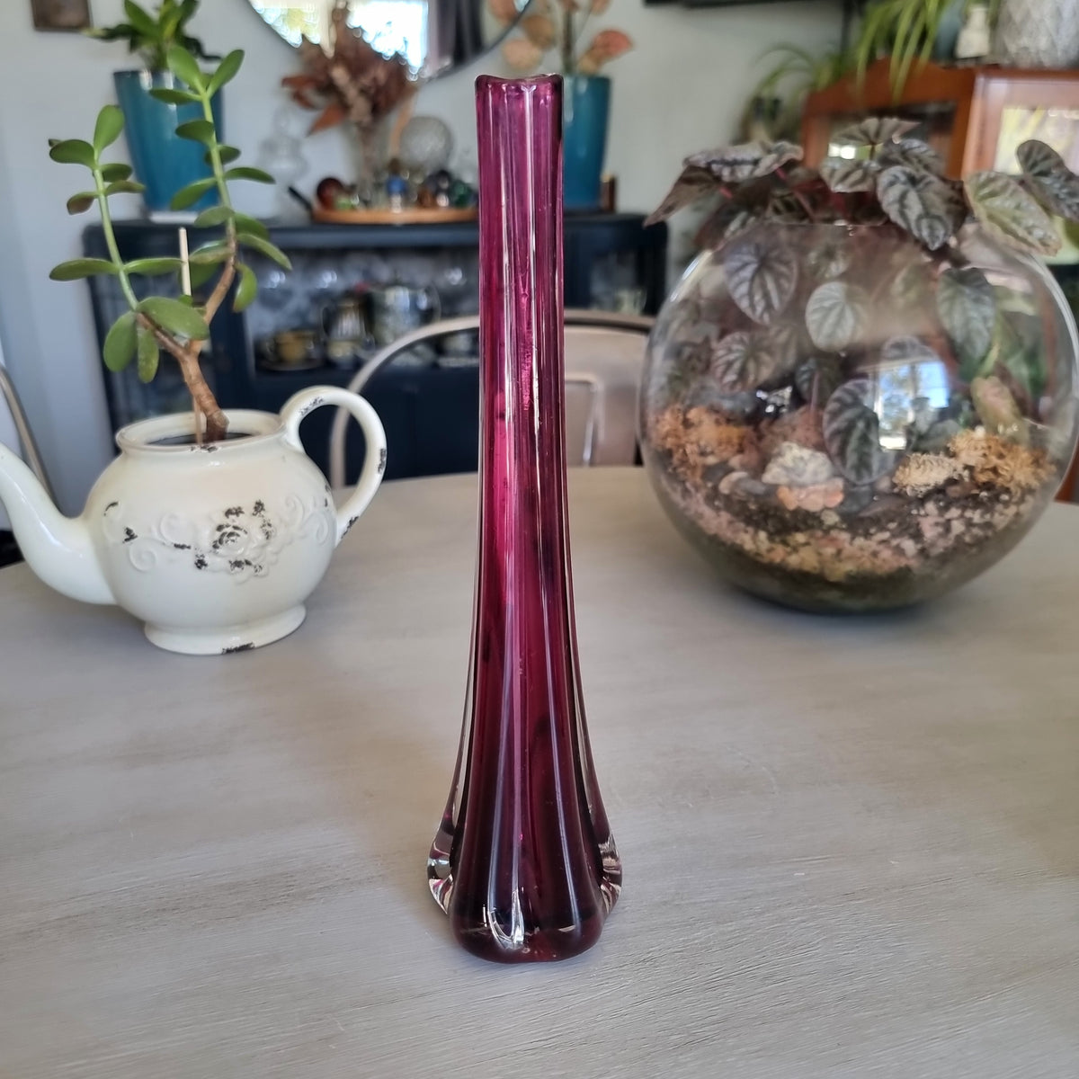 Tall vintage purple glass bud vase with ribbed sides and a heavy clear glass base