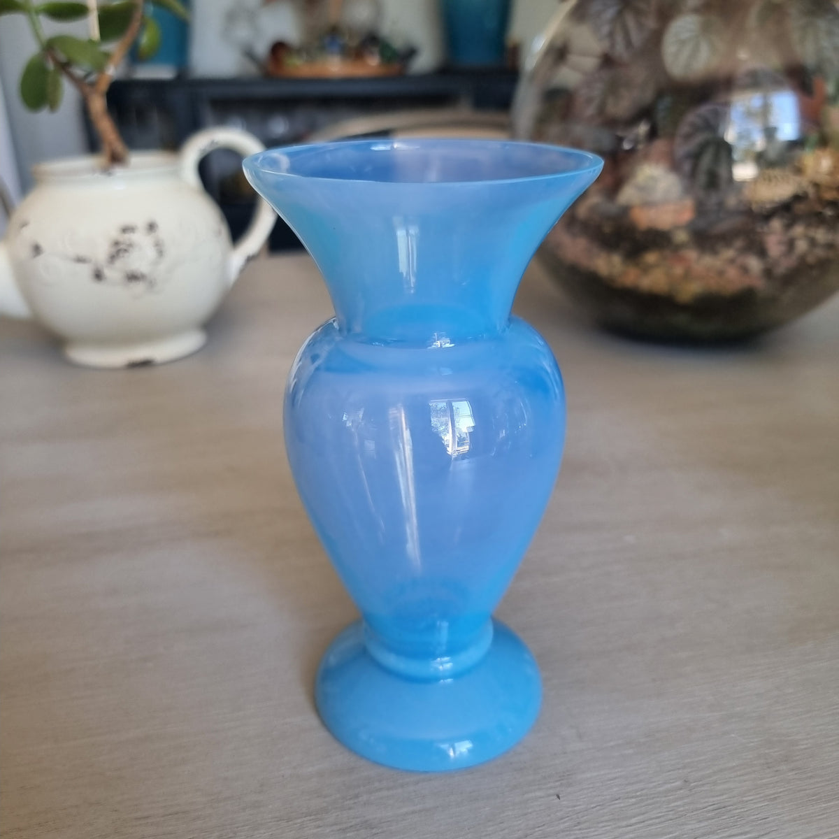 Vintage milky blue glass vase with a rounded body, flared rim and pedestal foot