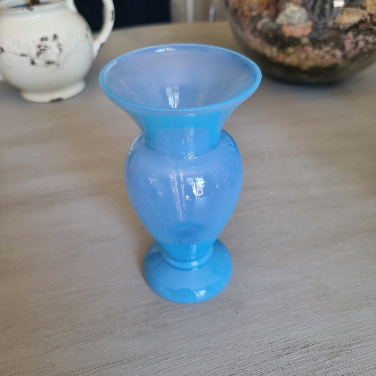 Vintage milky blue glass vase with a rounded body, flared rim and pedestal foot