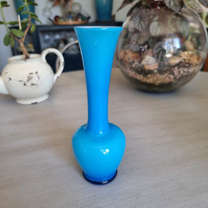Vintage bright blue cased glass bud vase with a rounded body and tall trumpet neck