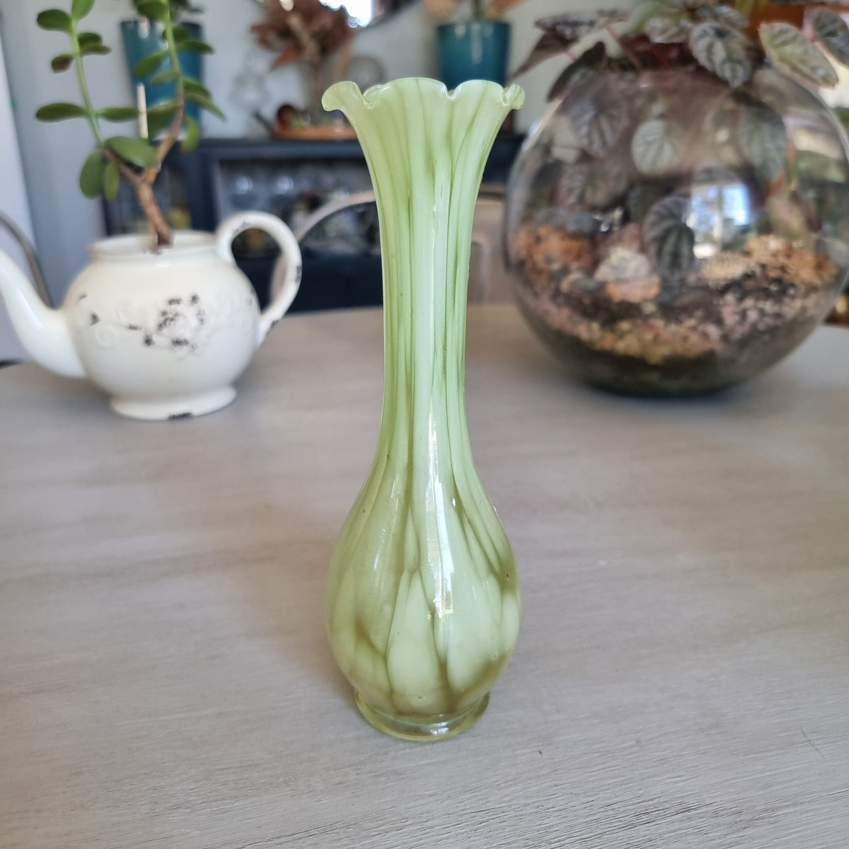 Retro pale green marbled glass vase with a slim neck and ruffled rim