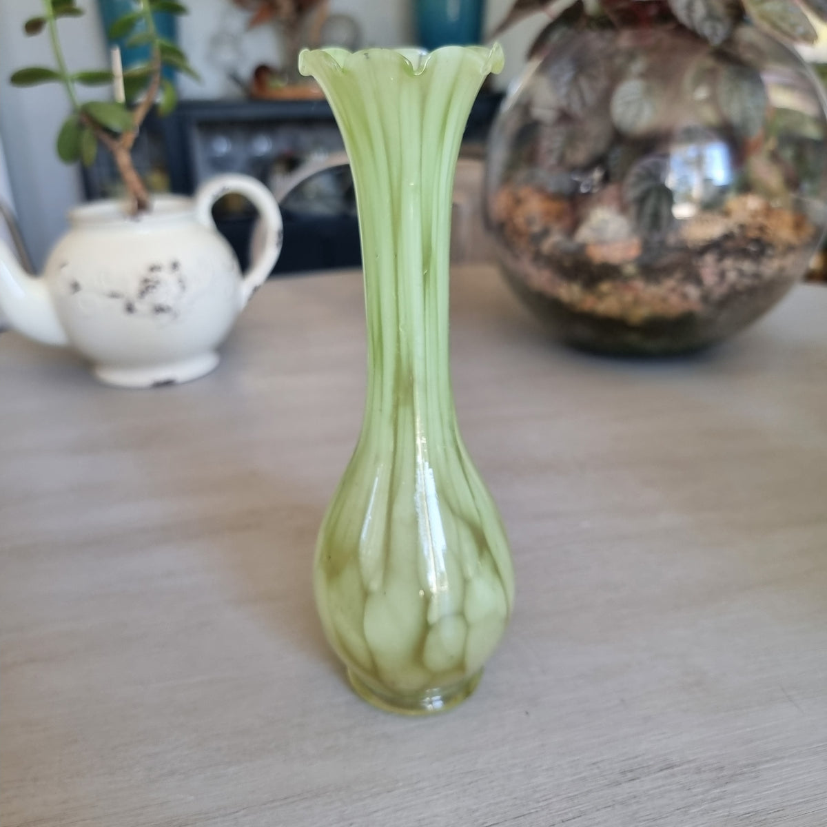 Retro pale green marbled glass vase with a slim neck and ruffled rim