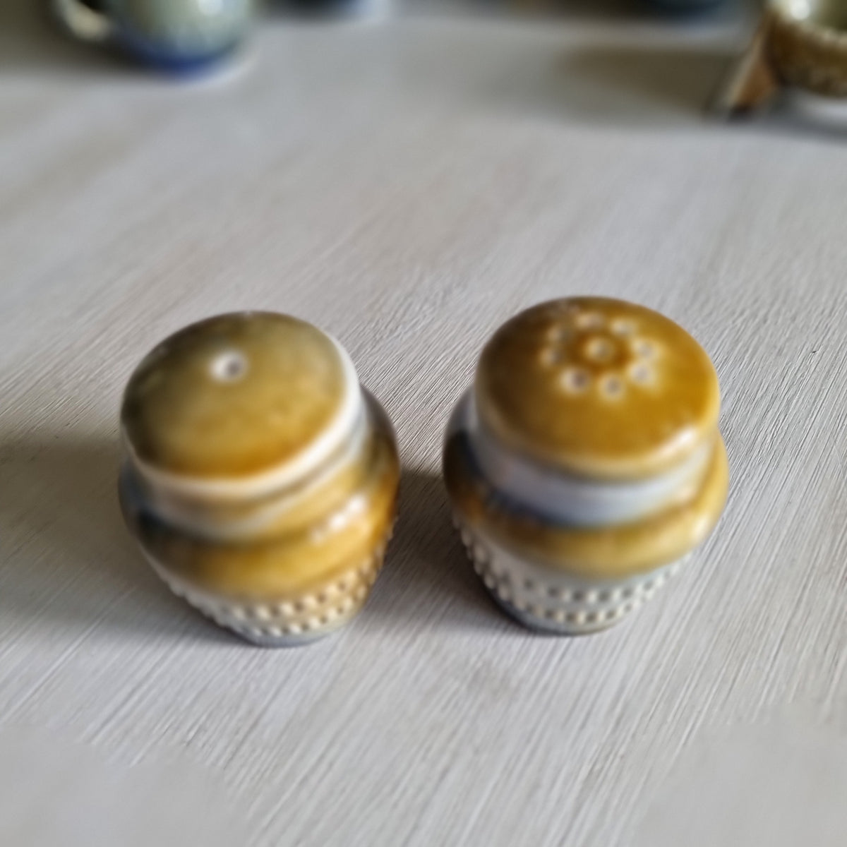 Pair of Wade Irish porcelain salt and pepper shakers in blue and brown glaze with raised beaded bands