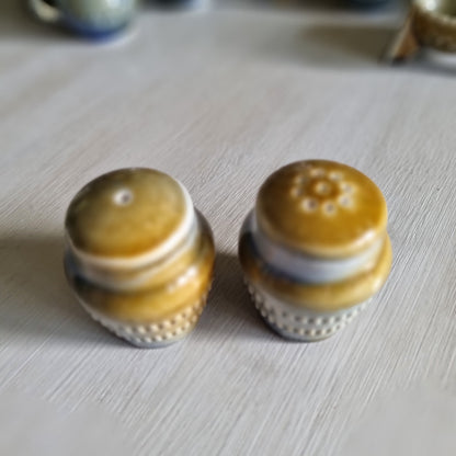 Pair of Wade Irish porcelain salt and pepper shakers in blue and brown glaze with raised beaded bands