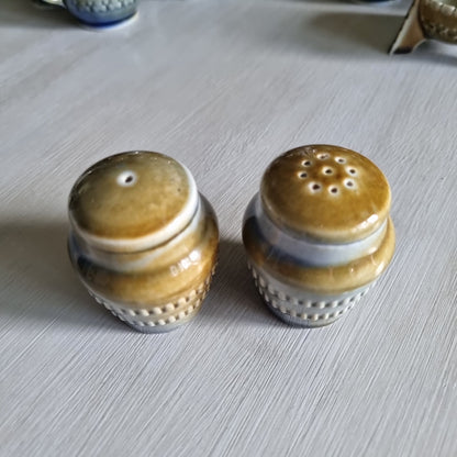 Pair of Wade Irish porcelain salt and pepper shakers in blue and brown glaze with raised beaded bands