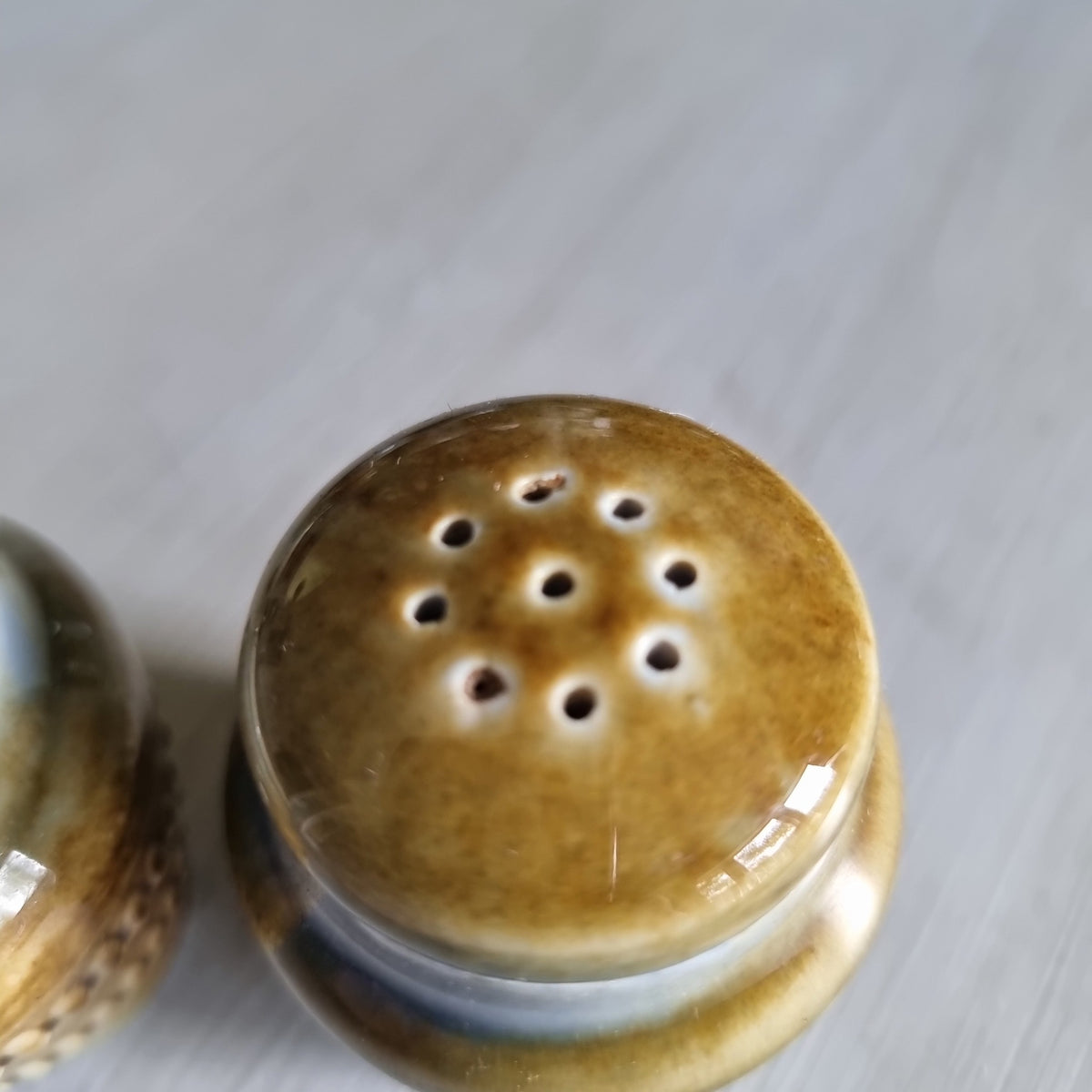 Pair of Wade Irish porcelain salt and pepper shakers in blue and brown glaze with raised beaded bands