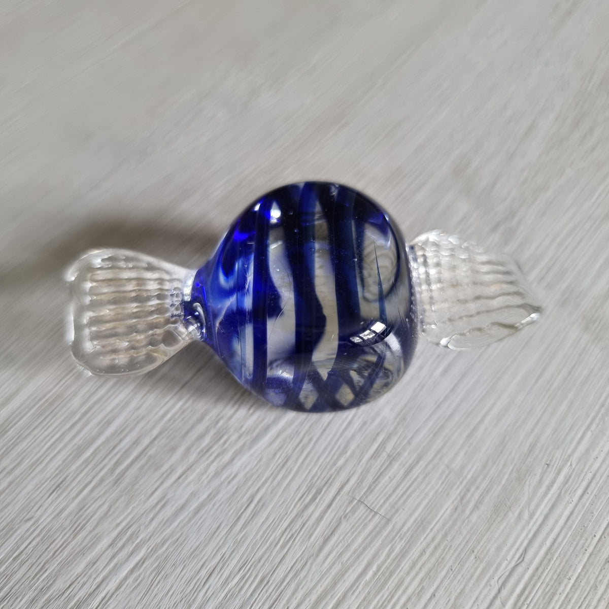 Blue and clear glass wrapped lolly ornament with cobalt swirls