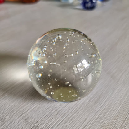 Clear glass paperweight with suspended bubbles