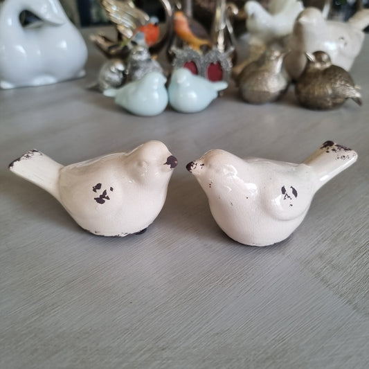 Pair of cream ceramic birds with chippy brown distressed detail